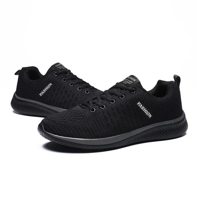 A pair of black athletic running shoes with a red interior lining and red accent along the midsole, featuring a breathable mesh upper and textured black rubber outsole for grip and flexibility.