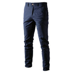 A pair of slim-fit navy blue men's trousers made from a smooth fabric. The pants feature a button and zipper closure, belt loops, and side pockets. The tailored design gives them a sleek and modern look, suitable for both casual and semi-formal occasions.