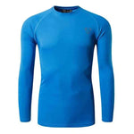A sleek, light gray long-sleeve compression shirt with a crew neck, featuring a small logo on the upper left chest. The fabric appears smooth and stretchy, designed for athletic or casual wear.