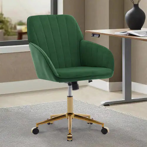 Green office chair with gold base in a room with a desk and window.