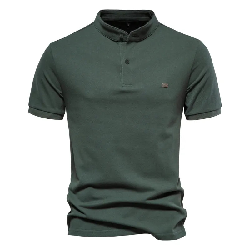 A beige short-sleeved polo shirt with a mandarin collar and a two-button placket. The fabric appears soft, and there is a small embroidered logo on the left chest. The shirt has a modern, slim fit with neatly stitched hems.