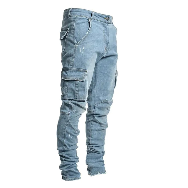A pair of light blue denim cargo jeans with a rugged, distressed design. The jeans feature multiple pockets, including large side cargo pockets with flap closures, front and back pockets, and subtle distressed details. The slim-fit design tapers towards the ankles, with a slightly ruched effect at the bottom hems for a modern, streetwear-inspired look