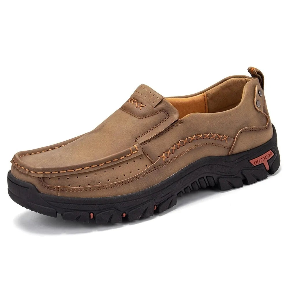 Brown slip-on casual outdoor shoe with moc-toe stitching, decorative seam details, and a chunky black rugged sole.