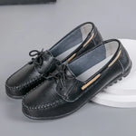 Black leather loafers with lace-up detail, moc-toe stitching, slip-on design, and black textured driving soles.