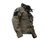 Olive-brown tactical-style jacket shown on a white background, featuring a high collar, multiple front straps and buckles, large flap pockets, and a black patch panel on the upper sleeve.