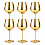 Set of six gold wine glasses on a white background