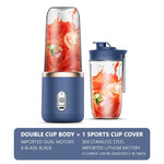 Blue portable blender with a clear cup filled with splashing strawberry drink, shown next to a matching sports-lid cup; caption reads “Double cup body + 1 sports cup cover” with feature text including dual motors, 6-blade blade, 304 stainless steel, and lithium battery.