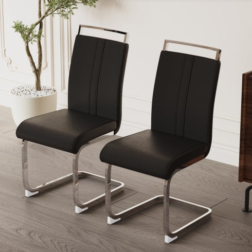 Two black chairs with metal legs on a wooden floor.