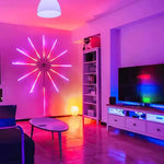 Colourful LED strip lights arranged in a starburst design on a living room wall.
