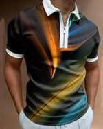 Person shown from chest to hips wearing a black short-sleeve polo with a white collar and half-zip, featuring an abstract multicolor light-streak design, with hands in pockets over light-colored trousers.