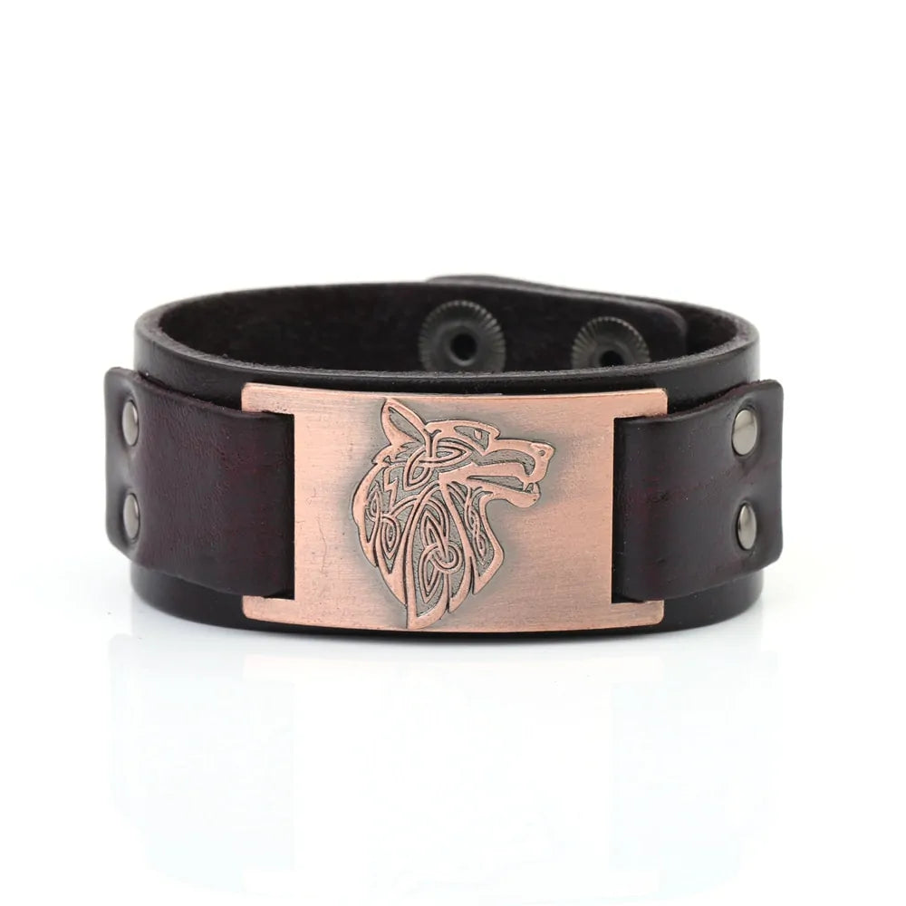 A black leather wristband with a braided design and a bronze-colored circular clasp featuring a paw print and runic inscriptions.