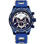 Blue analog chronograph wristwatch with a chunky metal case, blue silicone strap, multi-dial face with orange accents, tachymeter markings, and a date window on a white background.