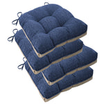 Blue tufted dining chair cushions stacked in a pile with tie fastenings.