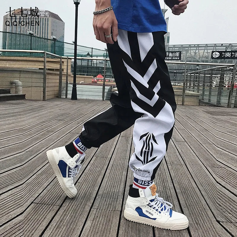 Men’s black and white graphic jogger trousers.

