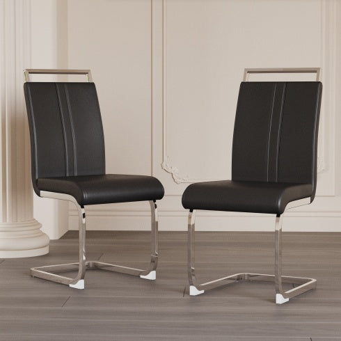 Two black chairs with chrome frames on a wooden floor.