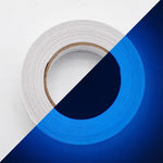 Roll of double-sided adhesive tape shown half on a white background and half on a blue background, highlighting the transparent tape.