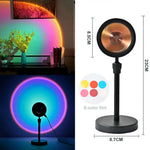 Collage of a small “sunset” projection lamp casting a rainbow halo on a wall, alongside a product diagram showing the black lamp on a stand with dimensions (about 23 cm tall) and a “6-color film” filter options graphic.