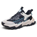 A black knit athletic sneaker with bright beige sculpted soles, matching orange pull tabs, and blue lace and strap accents. The side strap is printed with “FASHION SPORT,” giving the shoe a bold, futuristic streetwear look.