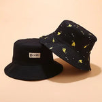 Black bucket hat displayed on a wire stand, with a yellow patch reading “HAVE A GOOD DAY” on the front and white numbers printed around the brim.