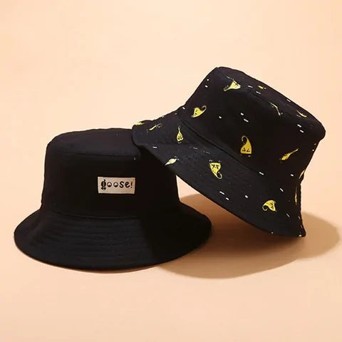 Black bucket hat displayed on a wire stand, with a yellow patch reading “HAVE A GOOD DAY” on the front and white numbers printed around the brim.