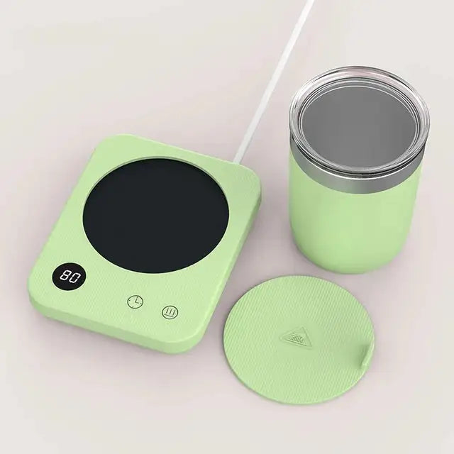 The image shows a green, modern mug warmer with a sleek, textured design. The warmer has a digital display showing the temperature (80°C) and control buttons for functionality. Alongside, there's a matching green mug with a stainless steel interior and a lid that features a small raised triangle. The set is designed for keeping beverages warm, with a clean, minimalistic look.