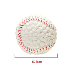 A white textured ball designed to resemble a baseball, featuring raised nubs across the surface and red stitched detailing. The image includes a size label indicating the ball measures about 6.5 cm in diameter.