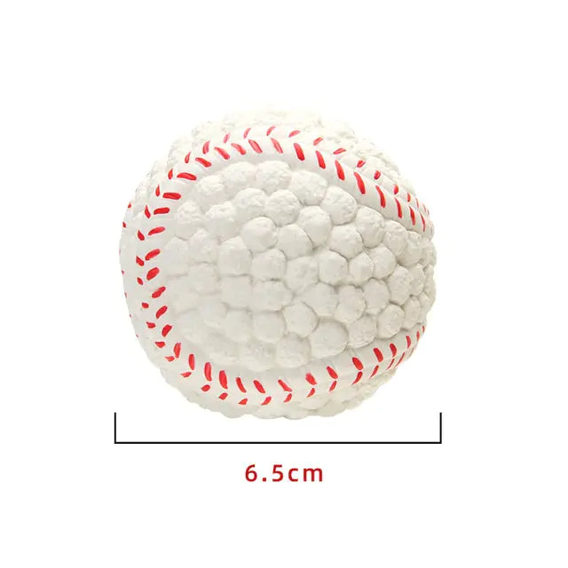 A white textured ball designed to resemble a baseball, featuring raised nubs across the surface and red stitched detailing. The image includes a size label indicating the ball measures about 6.5 cm in diameter.