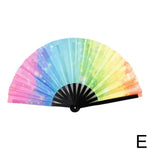 A colorful folding fan with a gradient pattern transitioning from pink to blue to green, with a sparkling effect, and black spokes and handle.