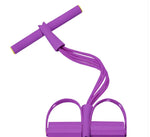 Pink resistance band exerciser with foam-covered handlebar and dual foot pedals, connected by four elastic tubes. Designed for home workouts, stretching, or strength training. Displayed against a white background.