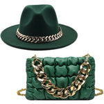 Dark green wide-brim hat and matching quilted shoulder bag with chunky gold chain detail.