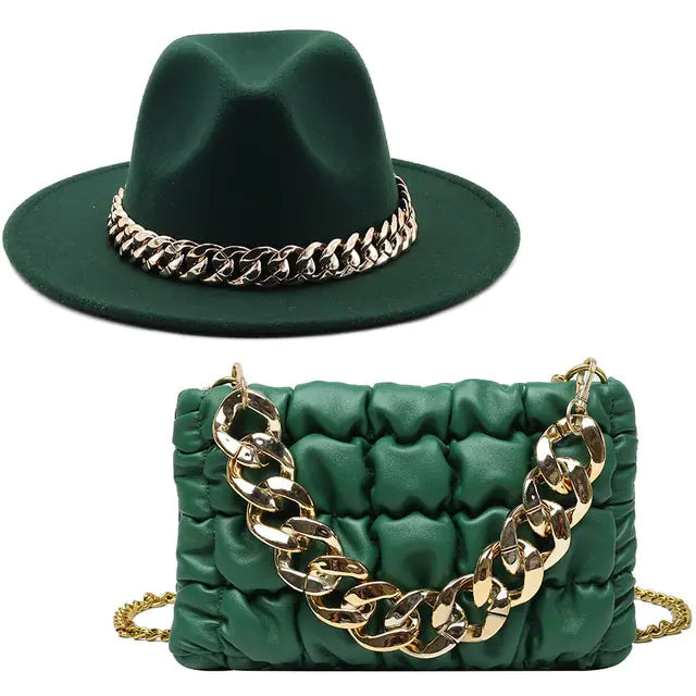 Dark green wide-brim hat and matching quilted shoulder bag with chunky gold chain detail.