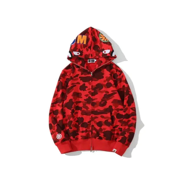 A red camo zip-up hoodie with a shark-face graphic on the hood and small orange patches on top, shown on a white background.