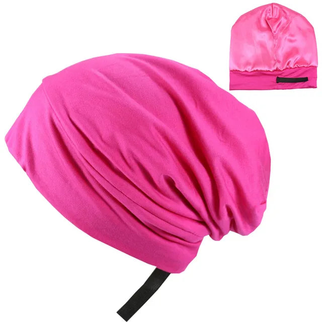 Bright pink satin hair bonnet with a gathered, slouchy shape, shown with a small inset image highlighting the back closure strap.