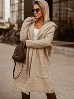 Woman wearing a beige cardigan with a blurred urban background
