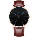 Analog wristwatch with a brown leather strap, rose-gold case, and a minimalist black dial featuring slim blue hour markers and the word “GENEVA” near the top.