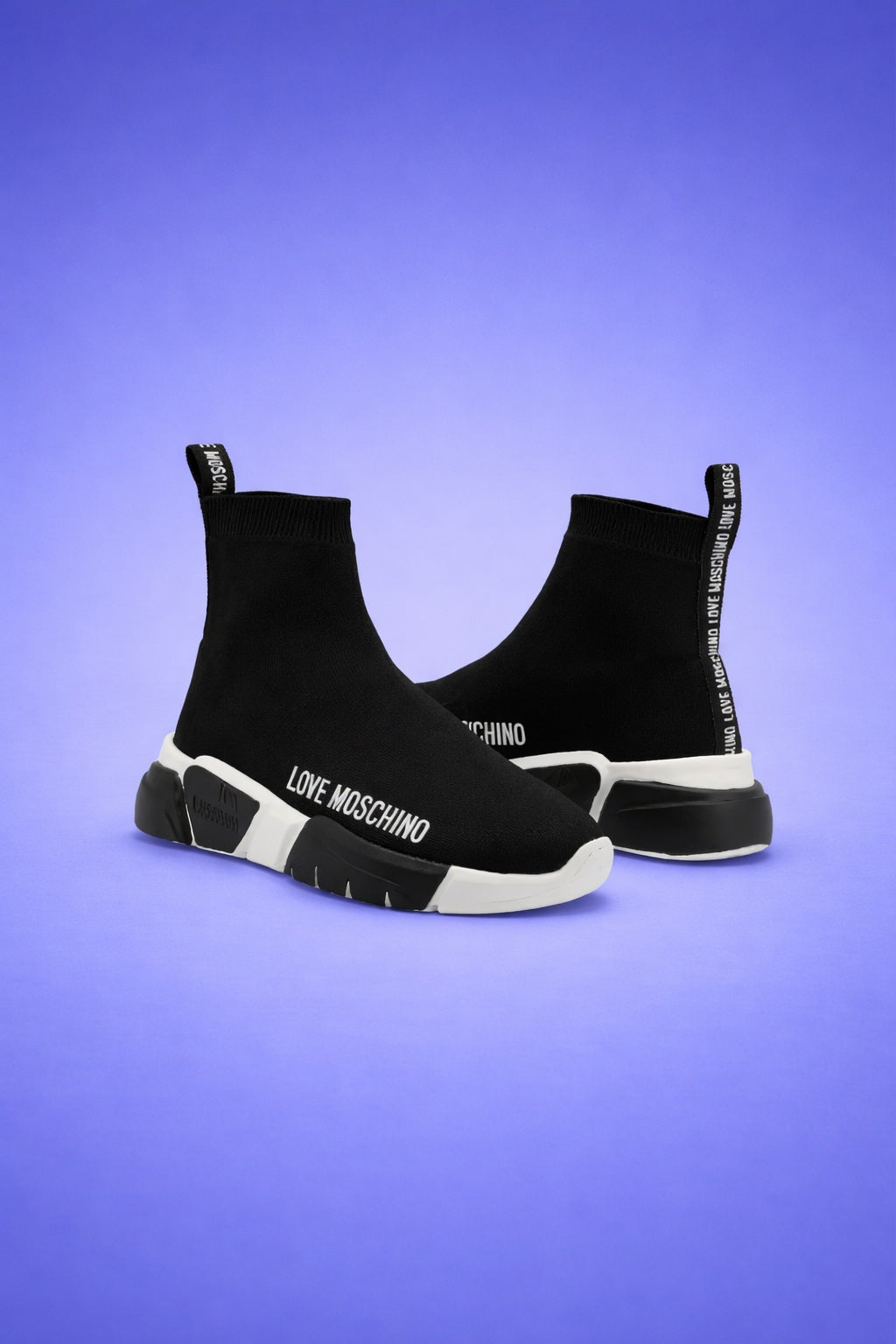 Black Love Moschino sneakers on a purple background