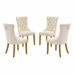 Set of four cream-colored dining chairs with wooden legs on a white background