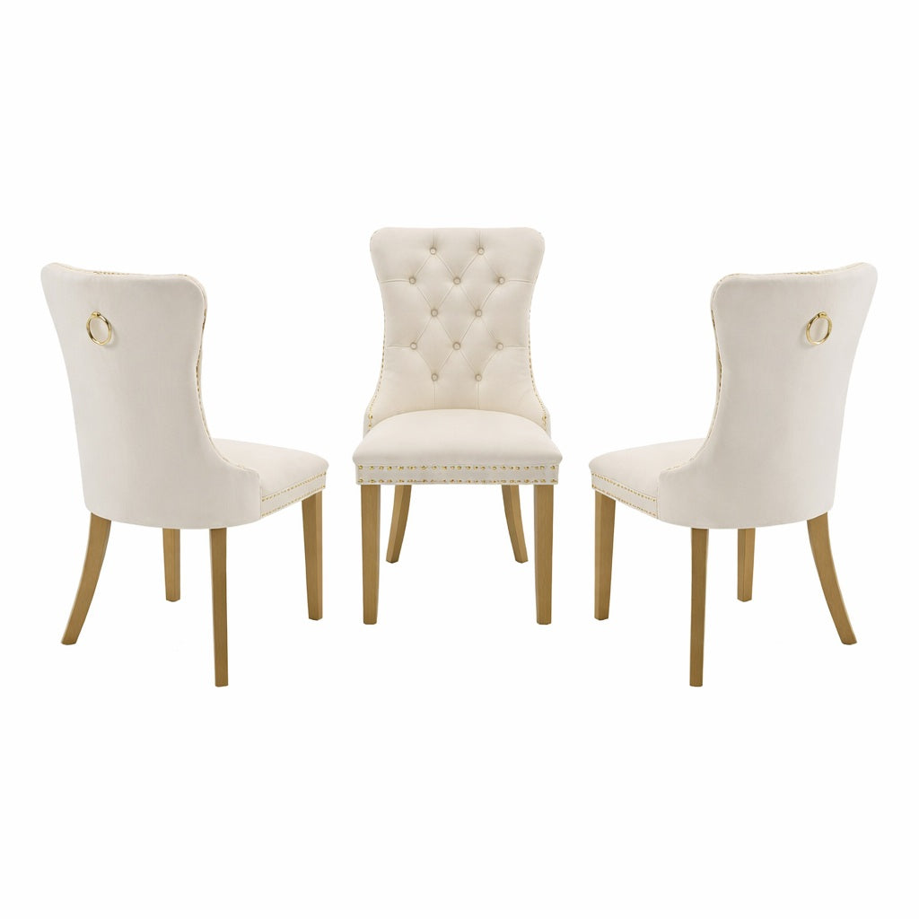 Three white upholstered chairs with gold accents on a white background