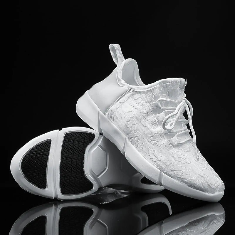 White lace-up trainers with floral textured fabric, chunky segmented soles and black grip tread.