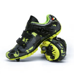 A pair of vibrant cycling shoes with a black and neon yellow camouflage pattern. The shoes feature a rugged sole with cleats, suitable for mountain biking or off-road cycling. They have two Velcro straps and a buckle fastening system for a secure fit. One shoe is placed upright while the other rests on its side, displaying the cleated sole.