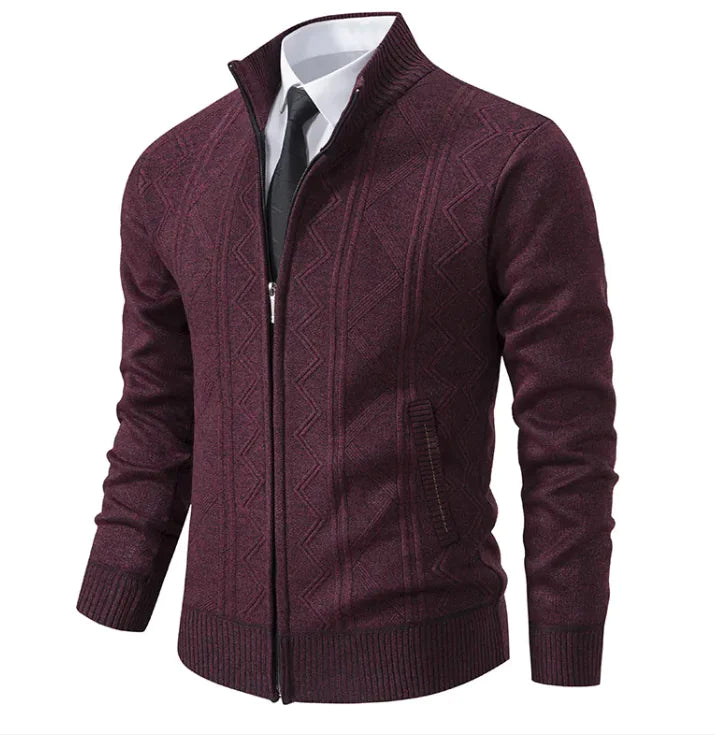 A stylish men's zip-up cardigan in a deep burgundy color with a subtle geometric pattern. The sweater features a ribbed collar, cuffs, and hem, and is worn over a white dress shirt with a black tie, giving it a formal yet modern look.
