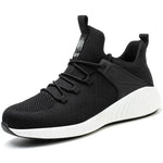 A black and dark gray athletic sneaker with a breathable knit upper, accented by bold orange wave-like stripes on the sides and orange detailing on the midsole. The shoe features a thick, textured sole and black-and-white patterned laces, designed for both style and performance.