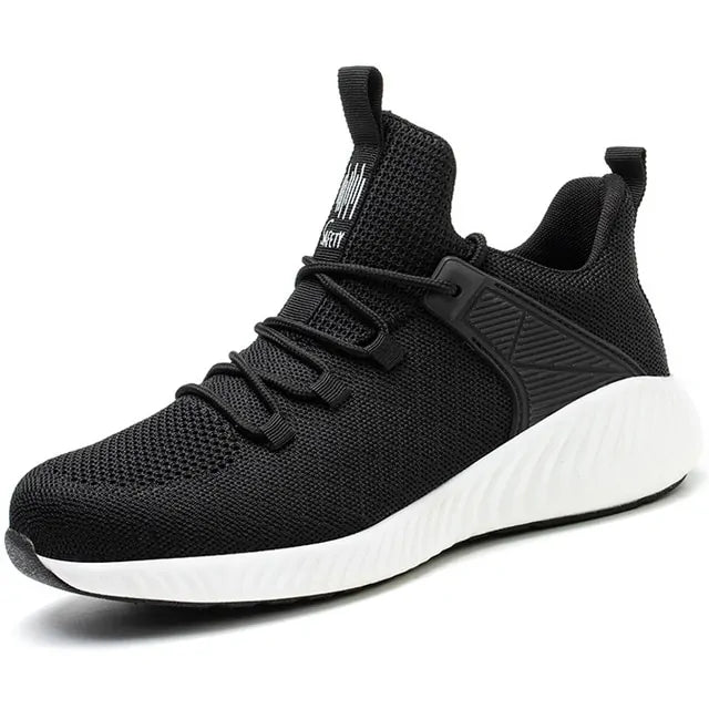 A black and dark gray athletic sneaker with a breathable knit upper, accented by bold orange wave-like stripes on the sides and orange detailing on the midsole. The shoe features a thick, textured sole and black-and-white patterned laces, designed for both style and performance.