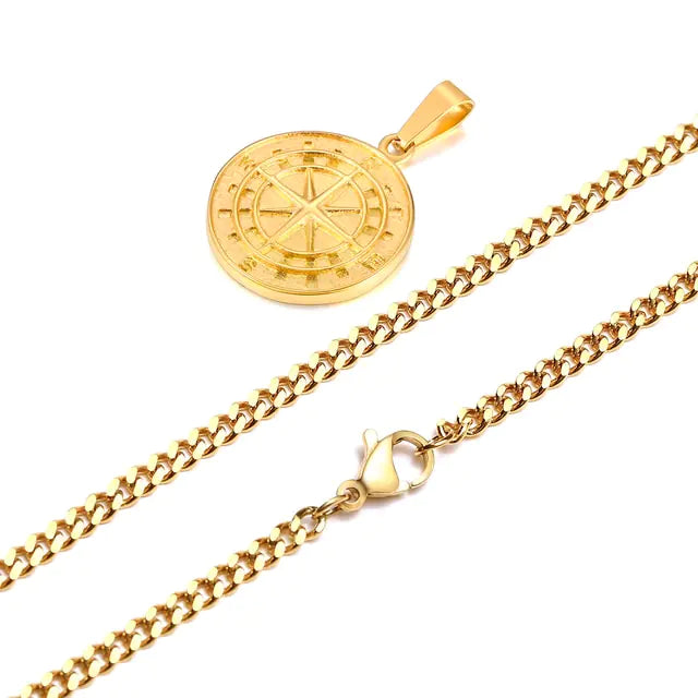 Gold-tone chain necklace with a round coin-style pendant featuring an engraved compass/star design, shown with a lobster clasp on a white background.
