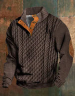 A dark brown men's pullover sweater with a textured cable knit pattern on the front. The sweater features a high ribbed collar with tan brown buttoned detailing, ribbed cuffs and hem, and matching tan elbow patches. The background consists of distressed, multicolored metal panels.