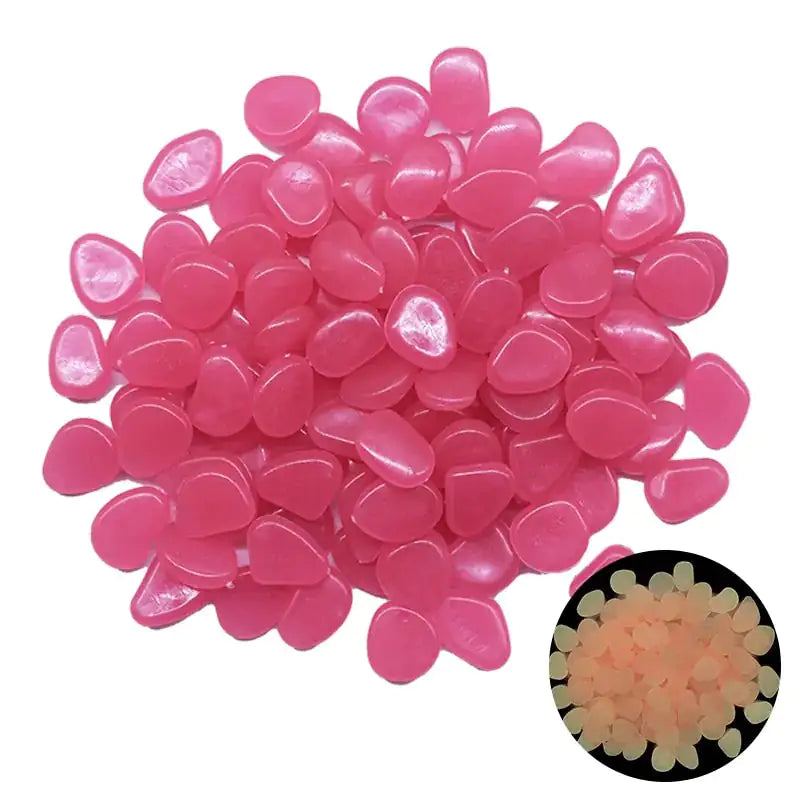 pile of small, smooth, pink teardrop-shaped pebbles on a white background, with a small inset photo showing the same pieces glowing a pale orange/yellow in the dark.