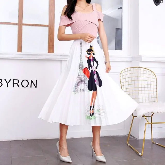 Pleated midi skirt with a gradient design, transitioning from dark black at the waistband to a soft blush pink at the hem, hanging on a black clothing rack next to a vintage-style camera.
