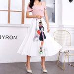 Pleated midi skirt with a gradient design, transitioning from dark black at the waistband to a soft blush pink at the hem, hanging on a black clothing rack next to a vintage-style camera.