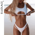 Person posing on a beach wearing a white two-piece bikini with a front cutout top and strappy high-cut bottoms; “ELLOLACE” text appears along the left side.