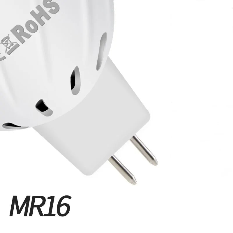 Close-up of an MR16 two-pin light bulb base with metal prongs and ventilation holes, on a white background.